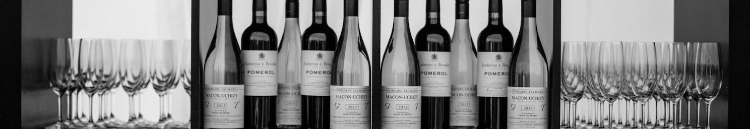 black and white, line up of wine bottles and glasses