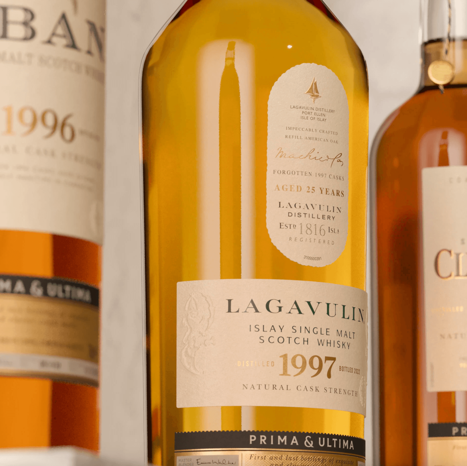 close up of whisky bottle with white label and two bottles beside it