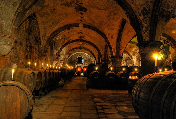 Candlelit cellar with barrels