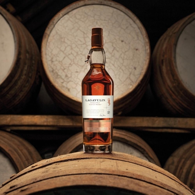 bottle of whisky on wooden casks