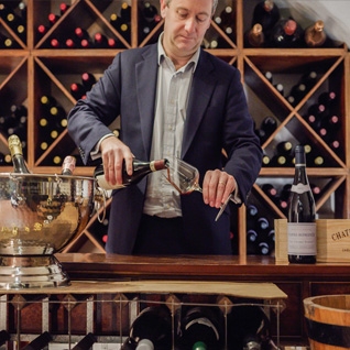 man pouring wine