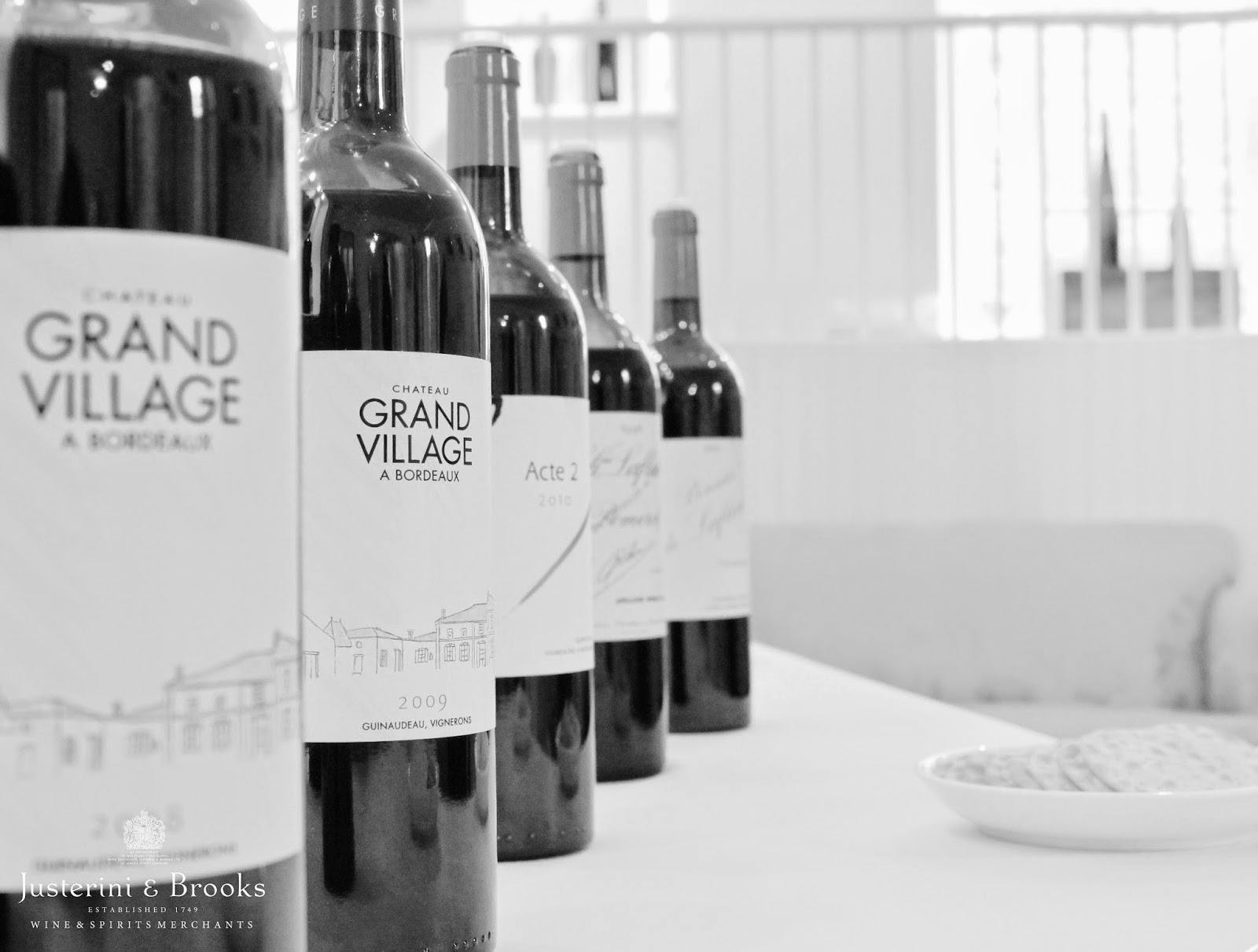 black and white, line of bottles on a table