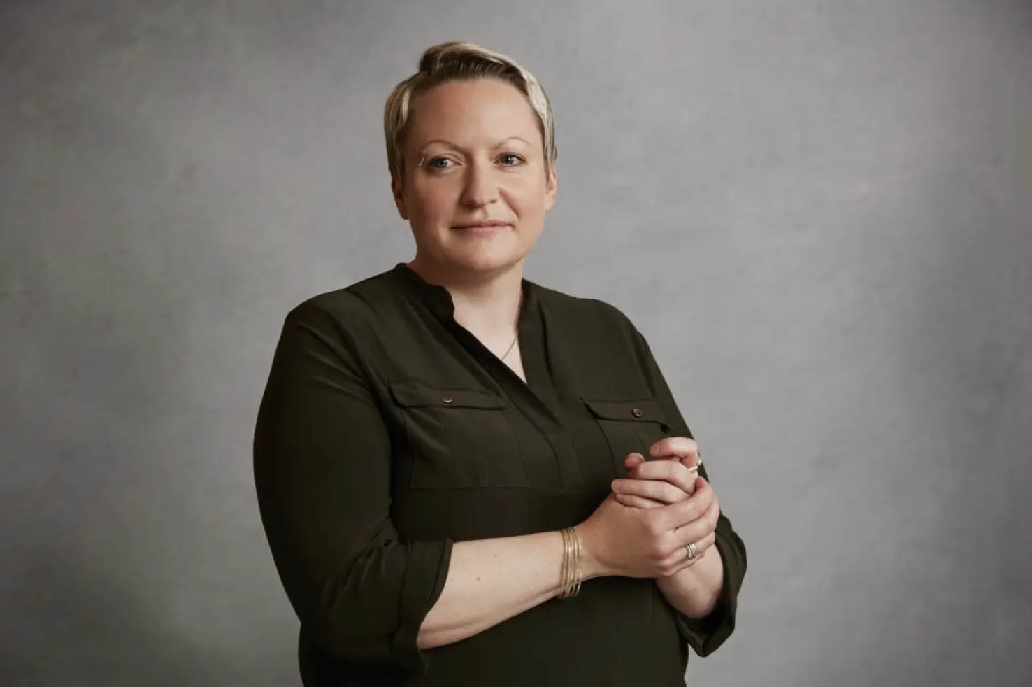 Woman standing in front of grey background