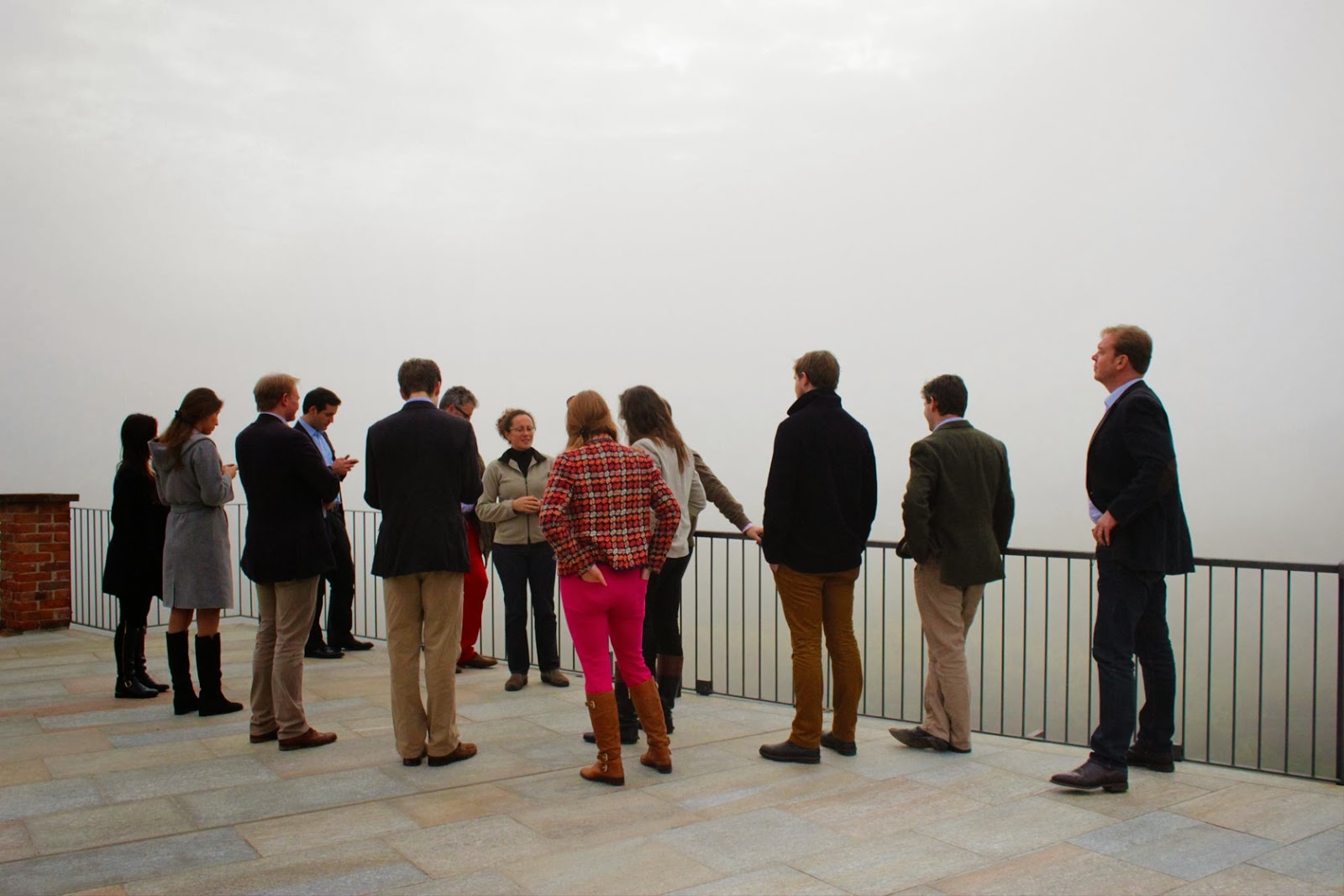 Group of people looking out over a foggy view