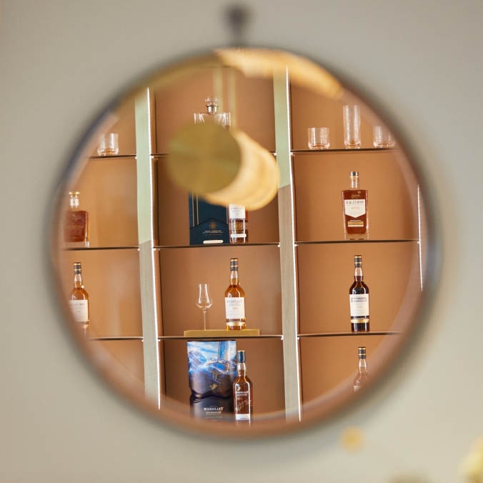 rounded shelf with bottles of whisky