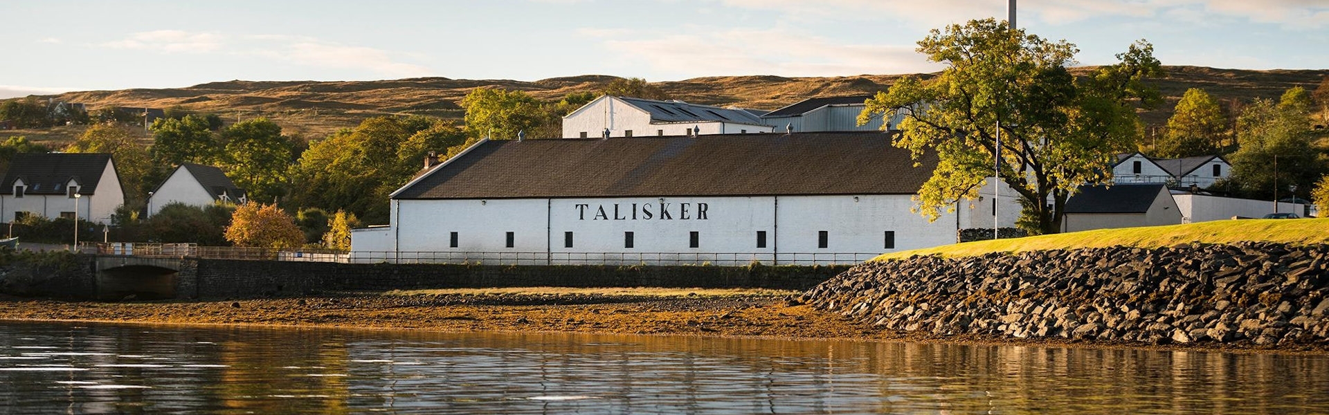 image of the distillery, white building next to sea