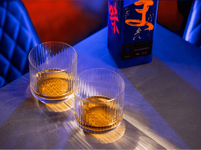 two glasses of whisky on table