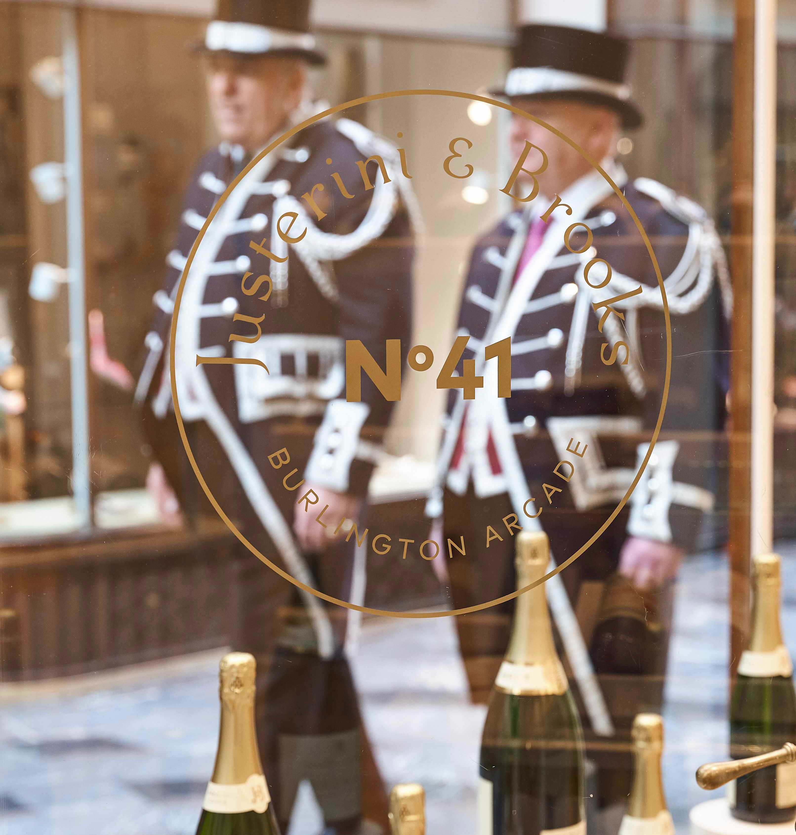 shop window of champagne with royal guards behind 