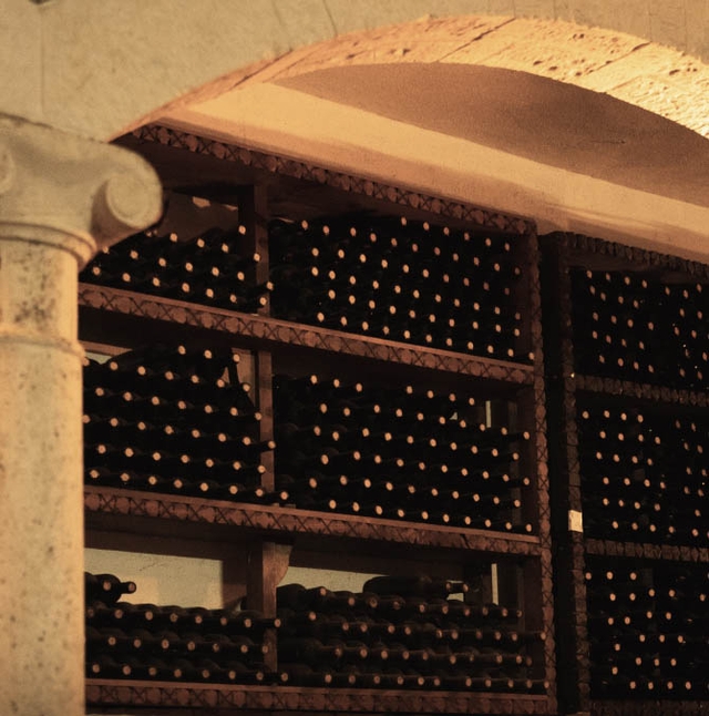 a wine cellar with lights in the shelves