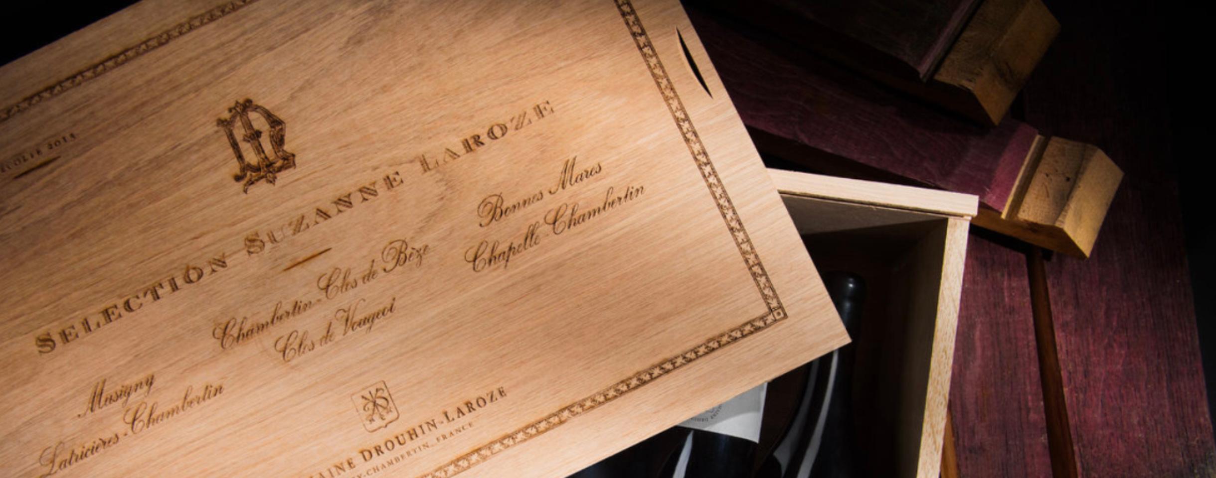 opened wooden box with wines inside