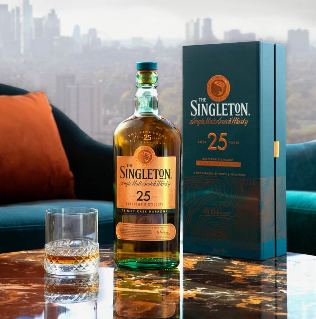 singleton whisky bottle next to a green branded box on a marble table