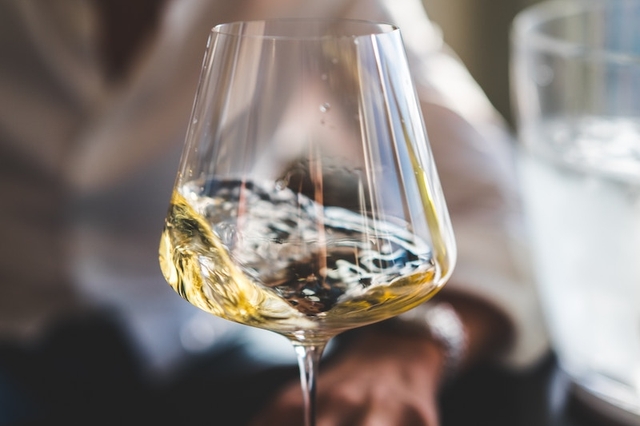 white wine in glass swirling
