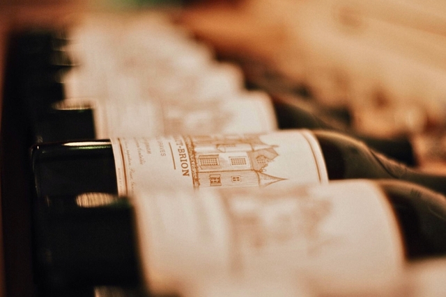row of wines laying down with white labels