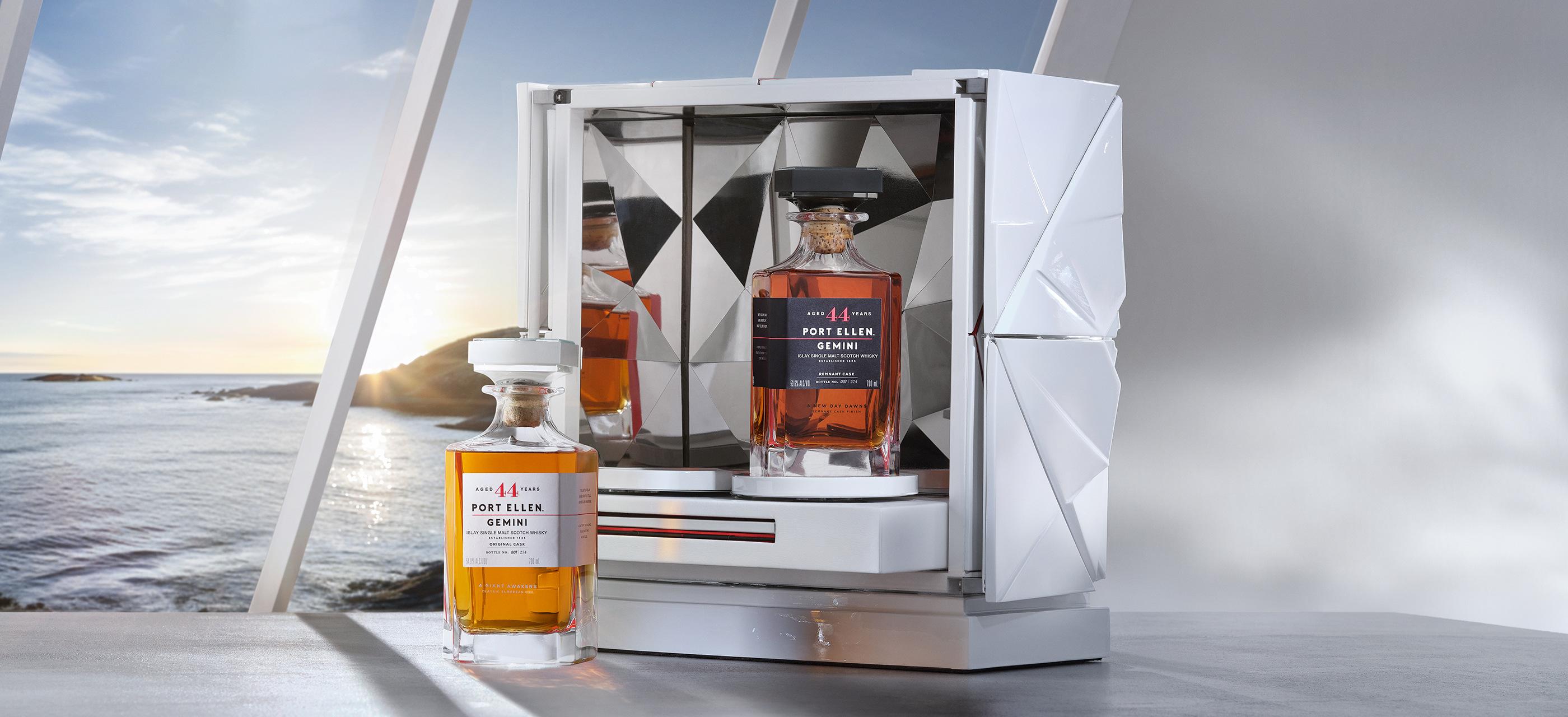 two bottles of port ellen gemini whisky staged in a white case against a scenic window with an ocean view