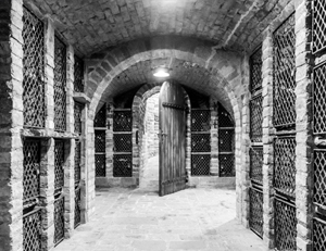 black and white image of a stone underground room