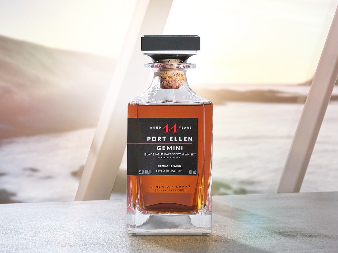 bottle of gemini remnant whisky from port ellen in front of a window with ocean view